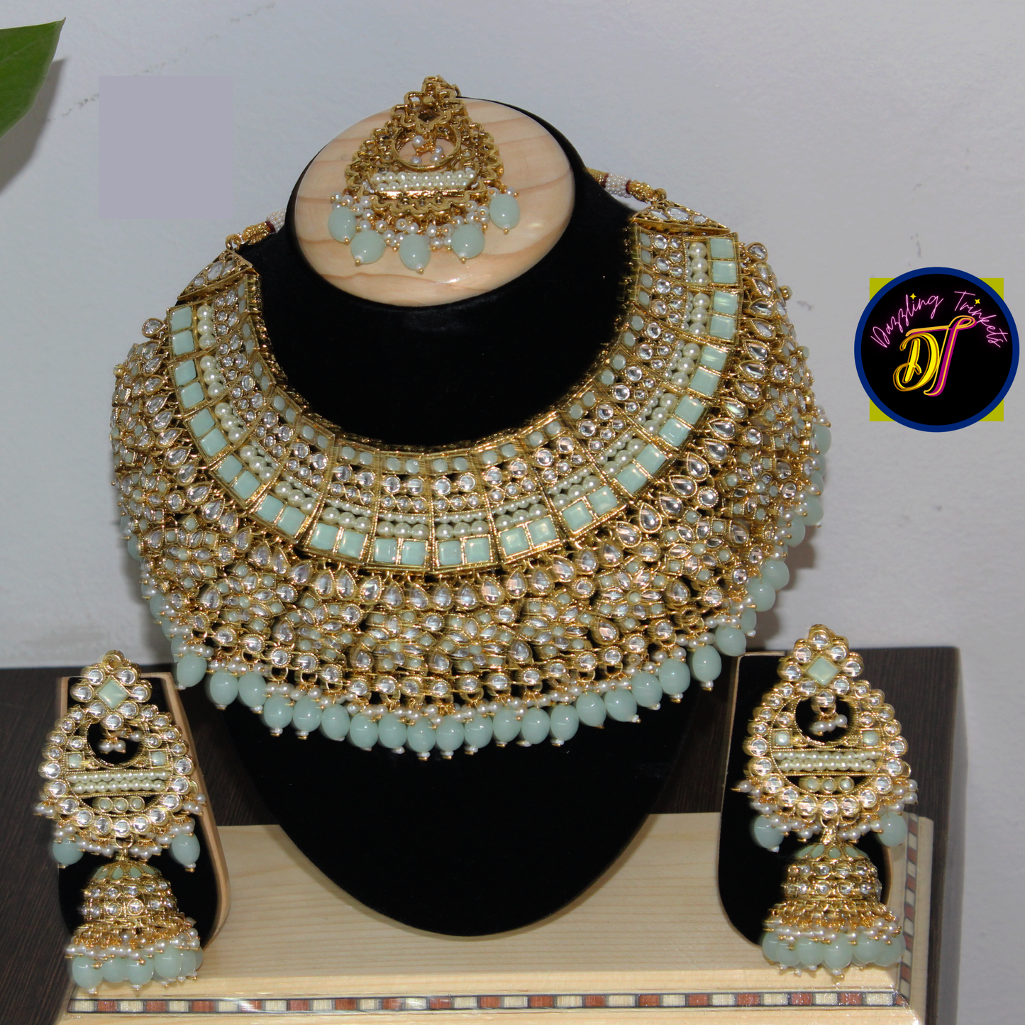 The image showcases the luxurious design and intricate detailing of the Kundan Chokar Necklace Set, available on www.dazzlingtrinkets.com. It exudes a sense of opulence and sophistication, perfect for special occasions or formal events.