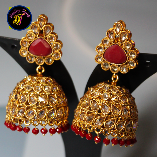 Kundan Polki Jadau Jhumka Earrings from Dazzling Trinkets. These exquisite earrings showcase the traditional craftsmanship of Kundan and Polki Jadau. The earrings feature intricate designs with a combination of Kundan and Polki gemstones, creating a captivating and regal look.